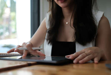 Closed up with businesswomen hands use tablet in office.の写真素材