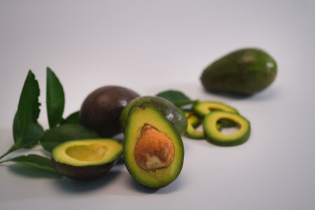 Closed up with avocado fruits and avocado slices on white back ground.の写真素材