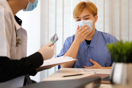 Asian male doctor in medical uniform give recommend medicine to patient at meeting in hospital.