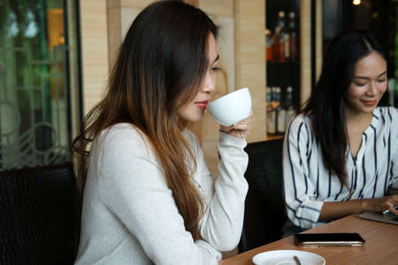Closed up with two business women enjoy with coffee break in meeting room.の写真素材