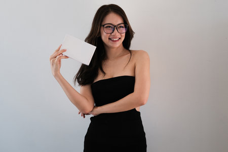 Portrait with Asian woman standing and holding white box package for presentation, dietary supplement, weight loss supplement.の写真素材