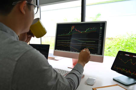 Closed up with businessman looking graph of trend chart stock market on computer, business and financial concept, business financial and stock trade concept.の写真素材