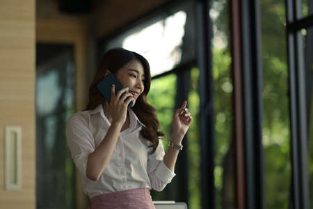 Portrait with businesswoman talking on smartphone.の写真素材