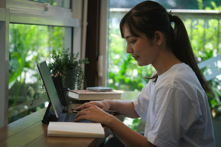 Portrait with young teenager using tablet on the cafe bar.