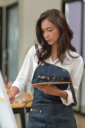 Artist women enjoy painting on the painting canvas, holiday activity concept.の写真素材
