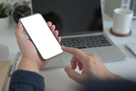 Closed up view of businessman hands using smartphone  at the office desk, empty screen of smartphone.の写真素材
