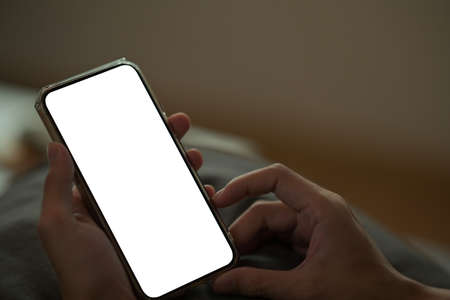 Closed up and cropped view with man use cellphone, empty screen of smartphone.