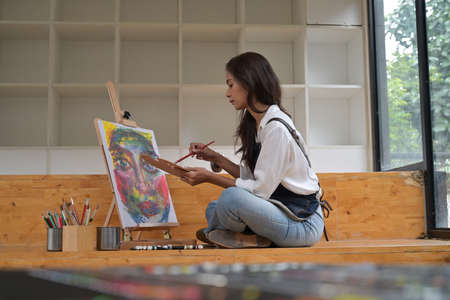 Portrait of the young talented female artist making sketches. Art, creativeness concept.の写真素材