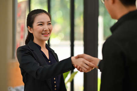 Photo of a young businesswoman making a deal with her business partner in the modern office.の写真素材