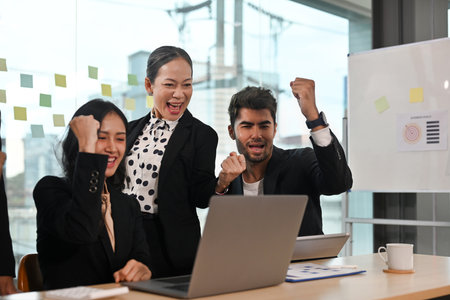 Excited mixed race different ages business people celebrating success achievement, raising hands and...