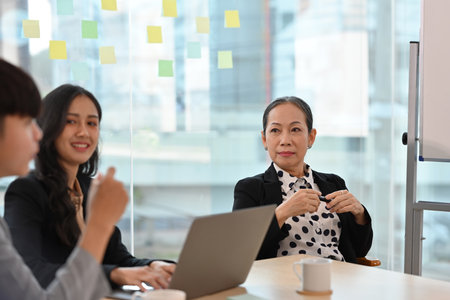 Senior Businesswoman meeting with her business team.の写真素材