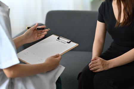 Focused Asian female doctor having discussion about patient diagnosis, holding an  application form...
