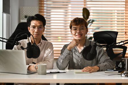 Two Asian male announcers Hosting a radio program, talks, interviews, announcements, advertisements.の写真素材