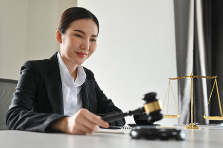 Smiling female lawyer holding judgment gavel hammer. Lawyer, attorney and justice concept.の写真素材