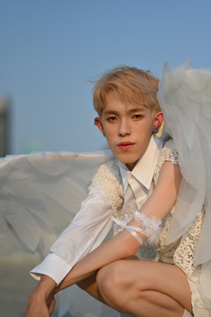 Portrait and vertical image with Attractive Young teenage boy in angel costume.