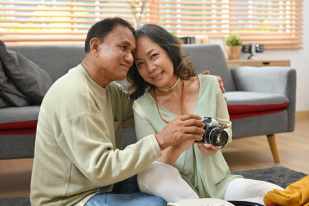 Asian retirement age couple preparing luggage for going on vacation.