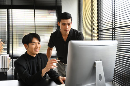 Office workers and colleagues working with computer in the office.