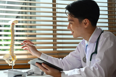 Doctor pointing spine model.の写真素材