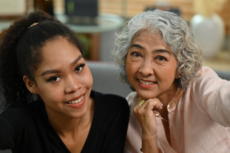 African adopted child and mother avoid taking selfies together.の写真素材