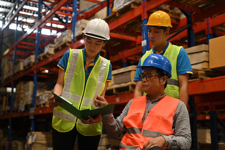 The supervisor in a wheelchair inspects the overview work in a warehouse. logistic business export management concept.の写真素材