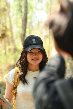 Close-up with teenage girl with a backpack looking to her friend, Trekking on summer vacations.の写真素材