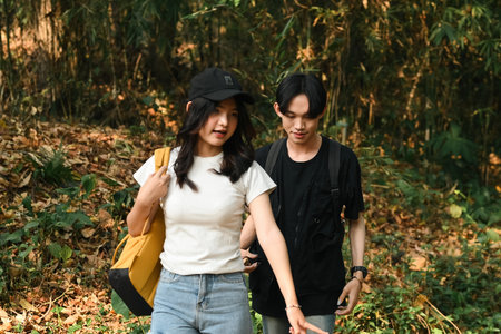 LGBT teenage queer couple, Hiking with Backpacks in forest in vacation.の写真素材