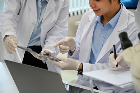 Close-up image of Lab team. Scientists, experimental experts of various ages discussing their research at the lab teamwork technician specialist profession of Science.の写真素材