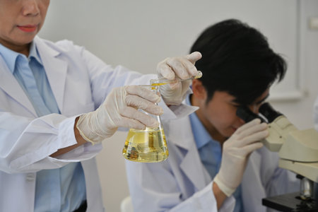 Close-up image of Senior Laboratory instructor woman mixes substances in a test flask conduct chemical experiments.の写真素材