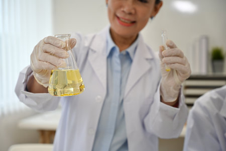 Close up image of Senior Laboratory worker woman mixes substances in a test tube.の写真素材