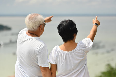 Senior Asian couple in love having fun by the sea.の写真素材