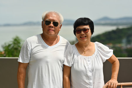 Portrait of a Happy Elderly Asian couple enjoying a good time on the travel at a seaside view, the Lifestyle After Retirement concept.の写真素材