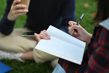 Selective focus on female hand talking note, college group education concept.の写真素材
