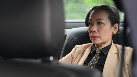 A seasoned professional senior businesswoman is finding clarity and focus during quiet moments in...