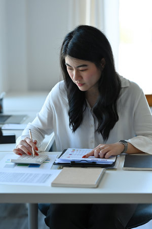 Asian businesswoman working with calculator for analyze business data, Business and financial...