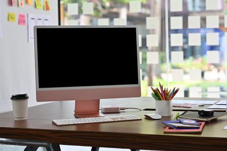 Close-up front view of a blank computer monitor screen with any gadgets and accessories on the...