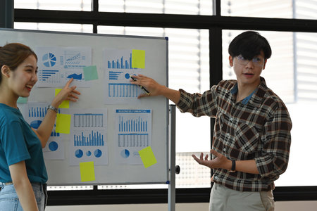 The Asian confident glasses man professional presents new research on his project with the partner...