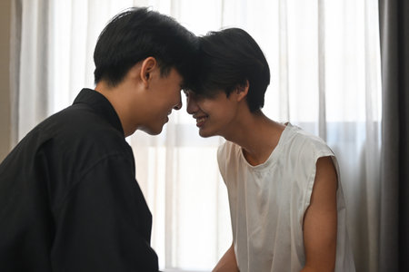 Asian young gay couple head to head and having an affection moment, Concept of same sex love, equality and LGBT rights.の写真素材