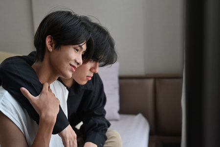 Portrait of Carefree LGBT Couple Indoors are hugging and embracing each other.