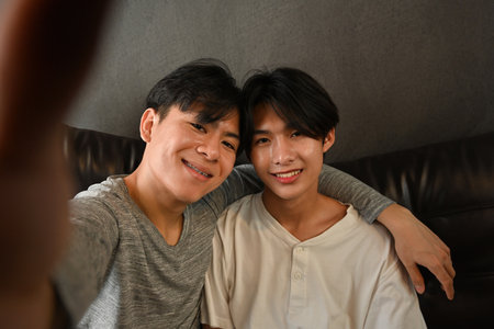 Pretty young LGBT couple having smile and taking selfie, LGBT Lifestyle concept.の写真素材