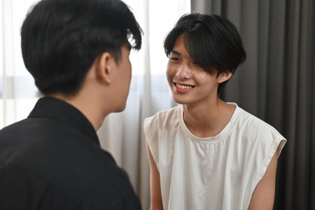 Two gay men looking together with warm eyes and love, LGBT, pride, relationships and equality concept.の写真素材