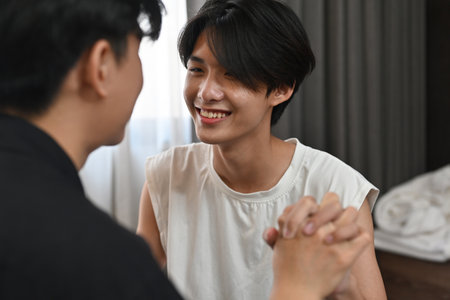 Close up with gay couple holding hands together, LGBT, pride, relationships and equality concept.の写真素材