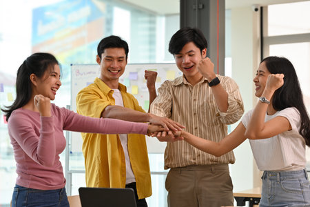 A portrait of  happy and successful businesspeople in casual outfits standing in the office working together. For teamwork business and financial.の写真素材