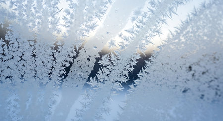 Frosty natural pattern on winter window glass. Abstract winter background