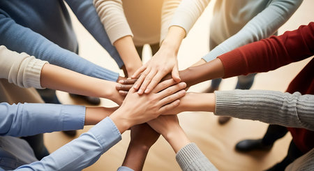 teamwork and people concept - close up of happy international team with hands on top of each other over office backgroundの写真素材