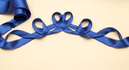 Blue ribbon on a beige background, symbolic photo for cancer awarenessの写真素材