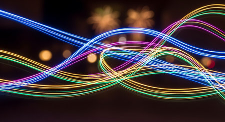 Colorful light trails on black background. Abstract background with copy space.