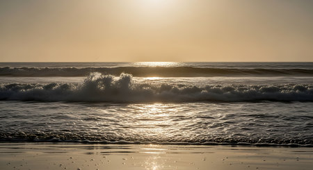 Sunset on the beach with waves in the foreground and sea in the backgroundの写真素材