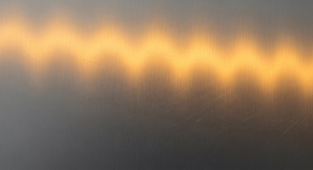 Metal background or texture of brushed steel plate with reflections Iron plate and shiny yellow lightの写真素材