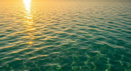 Sunset on the sea. Sea water surface with sunbeams.の写真素材
