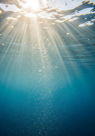 Underwater view of sunbeams breaking through the water surface.の写真素材